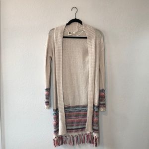 Long sleeved cream sweater with colorful stripes